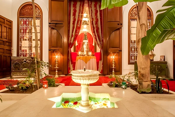 Riad courtyard with fountain and candles, Marrakech